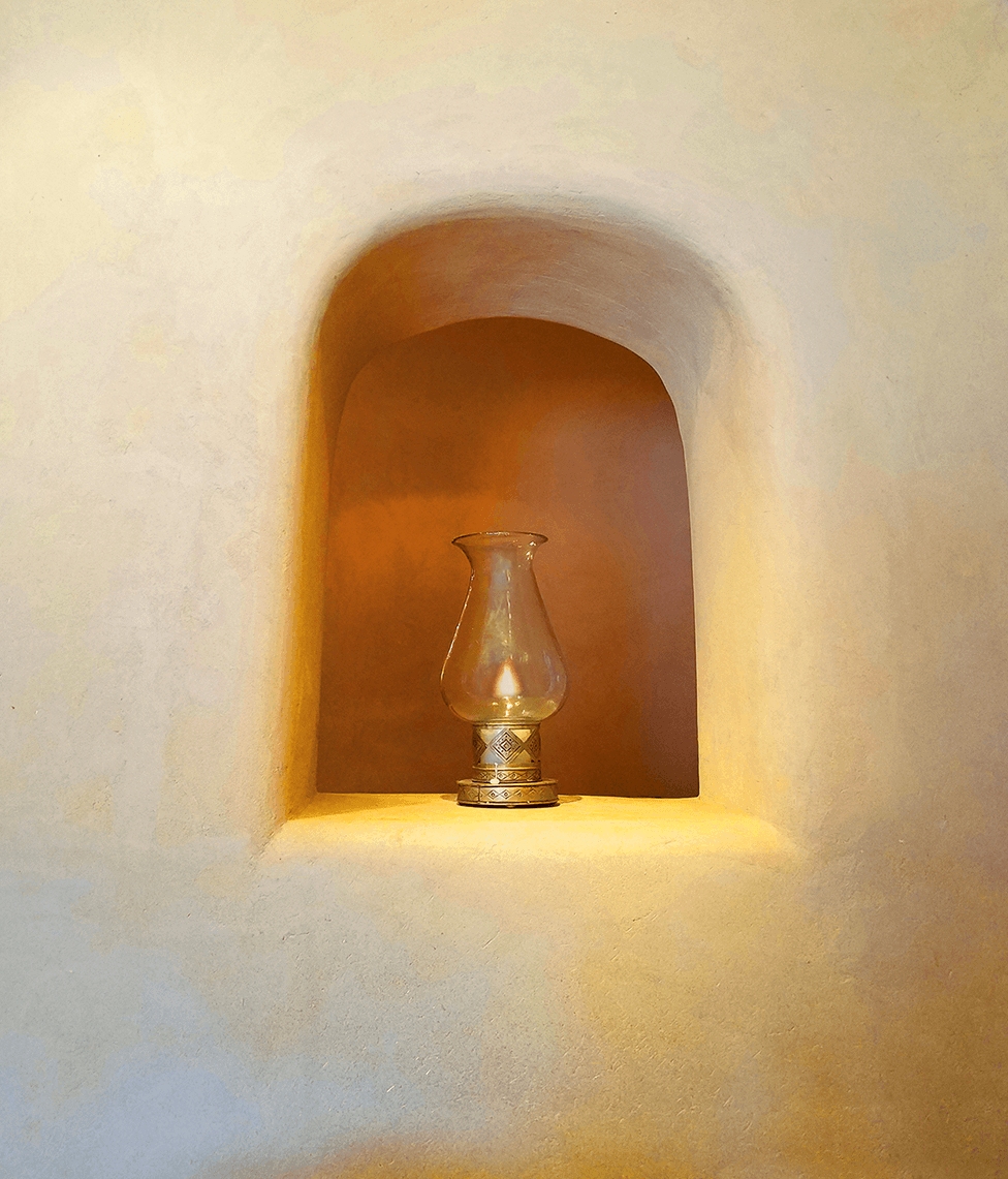 Wall with shelf lamp lighted